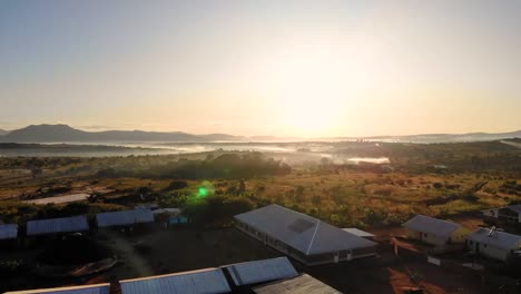 Siedlung-Des-Flüchtlingslagers-Dzaleka-Bei-Sonnenaufgang,-Drohnenanflug,-Goldene-Stunde