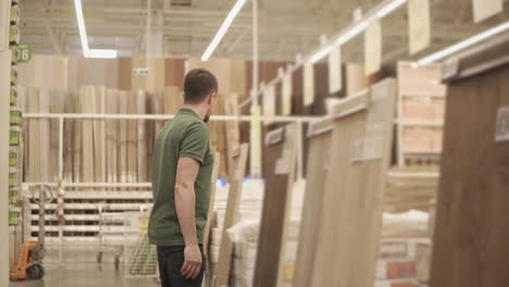 man shopping for flooring in a home improvement store