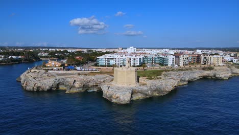 castle sitting on the cliff edge in ciutadella de menorca, spain