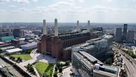 cinematic aerial panorama of battersea, london, revealing the redeveloped battersea power station, lift 109, riverside walkways, and murky thames waters