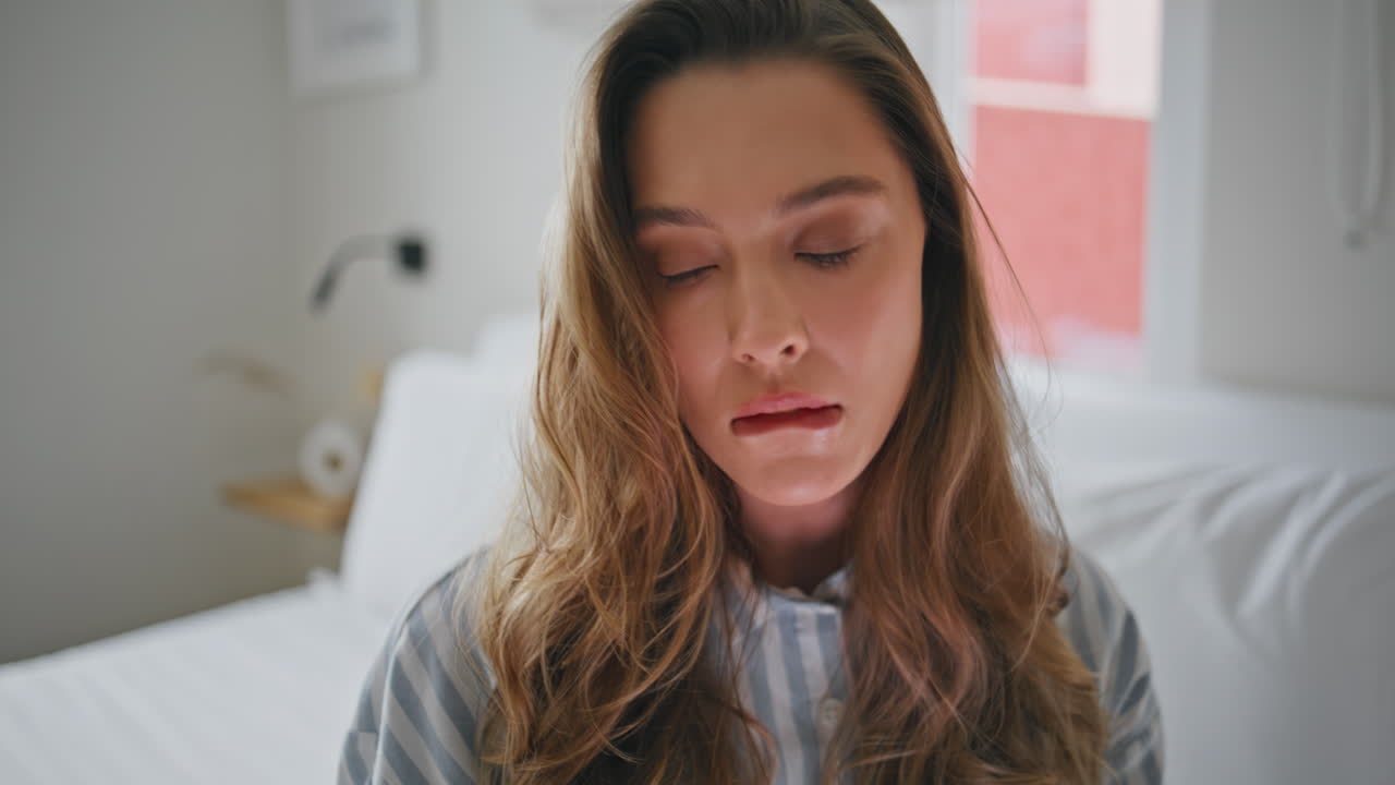 Pensive woman reading content on smartphone at home bed closeup. Thoughtful girl