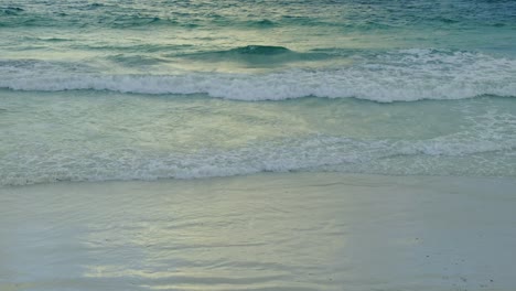 green-blue-ocean-waves-coming-ashore-on-a-sandy-beach