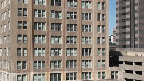 Zoom-In-To-The-Windows-Of-An-Older-Office-Building-To-Show-The-Blinds-Askew