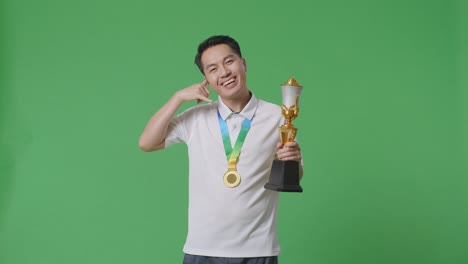 man celebrating victory with trophy and medal