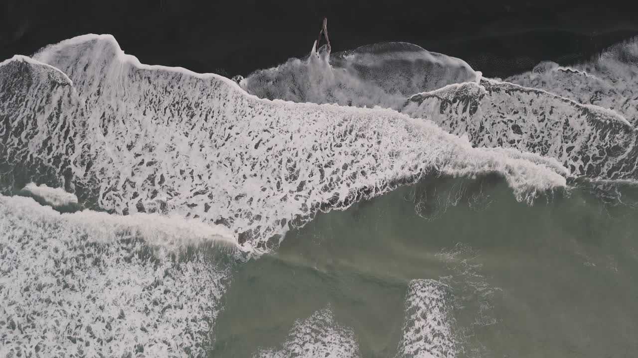 Aerial View of Waves Crashing on the Shore