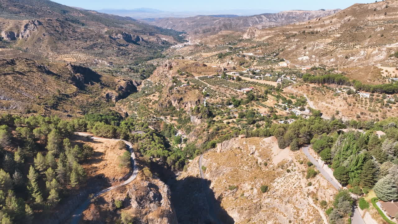 Flight across the dam walls and dramatic ravine drop of Granada's Lake Quentar