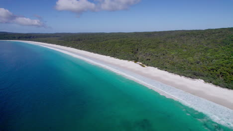 scenic drone shot of hyams beach, shoalhaven near jervis bay. pristine white sands and turquoise waves create a peaceful coastal scene on australia’s beautiful south coast.