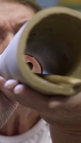 close-up view of a person working with clay