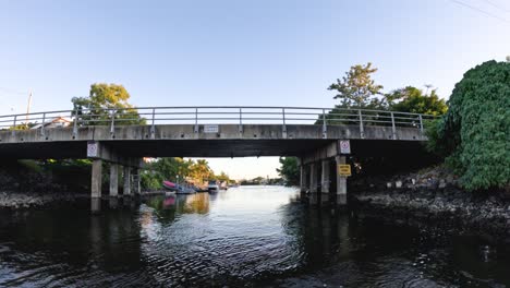 scenic view under a bridge over a calm river