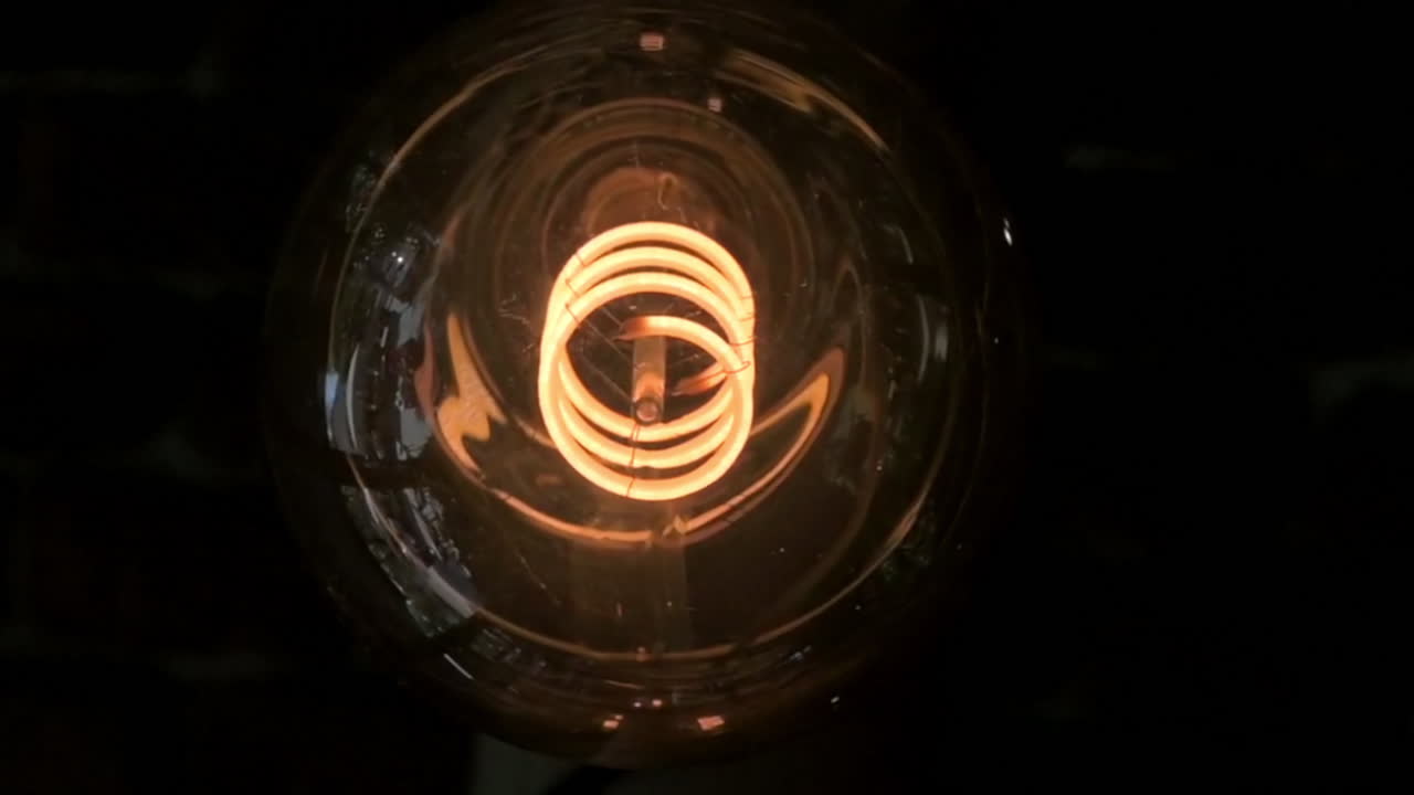 Close up of a cozy, dimly-lit setting with vintage-style filament light bulbs hanging from the ceiling