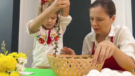 mother and daughter decorating easter eggs