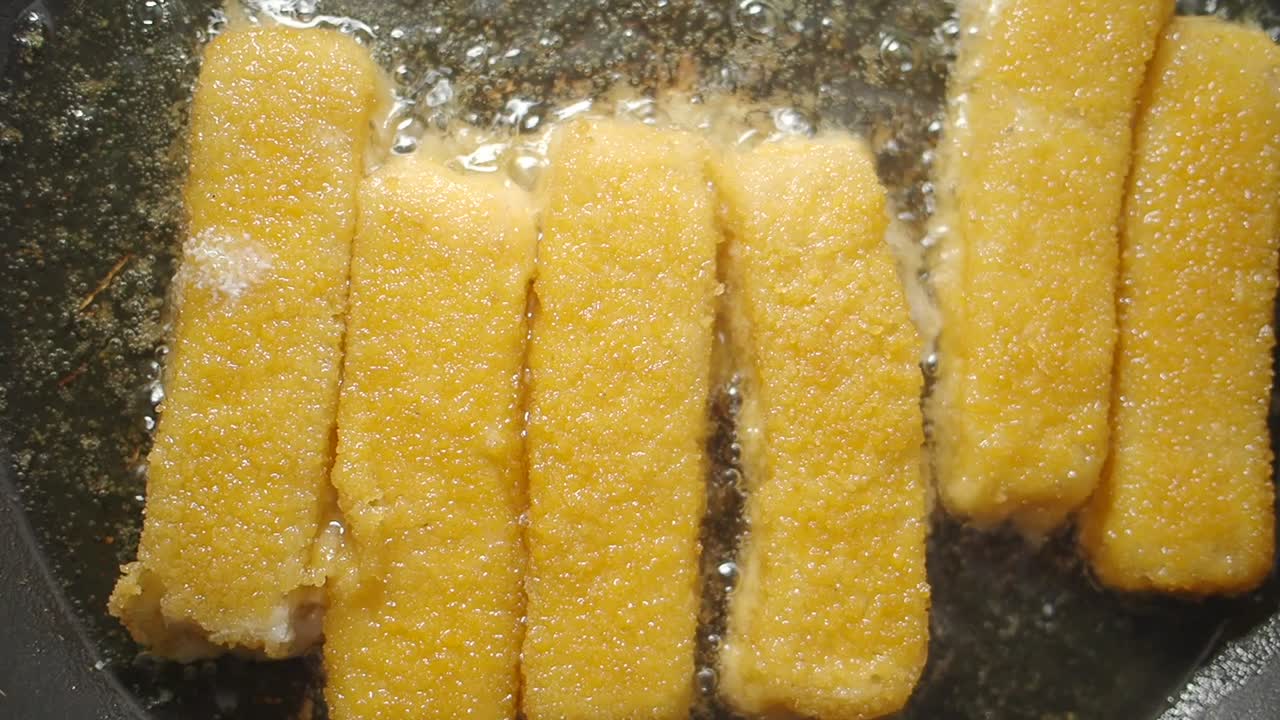Golden Fish Sticks Sizzling in Hot Oil