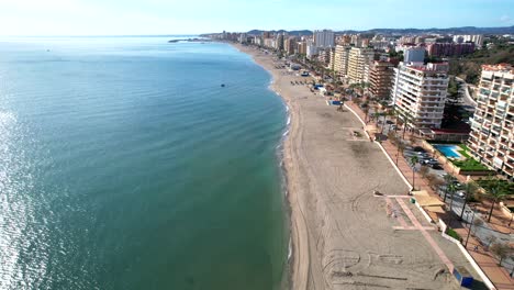 descending aerial dolly over waves on fuengirola hills beach