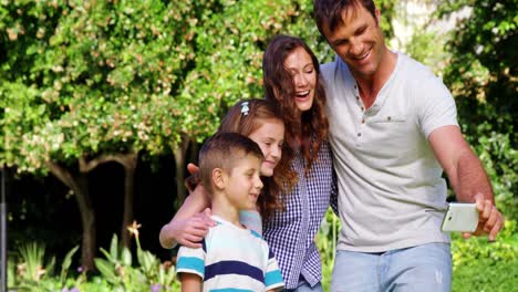 Happy-family-taking-a-selfie-on-mobile-phone