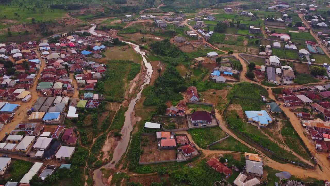 Stunning aerial of slums in the outskirts of Abuja, the capital city of Nigeria, Africa. A dry creek runs through the shanty town