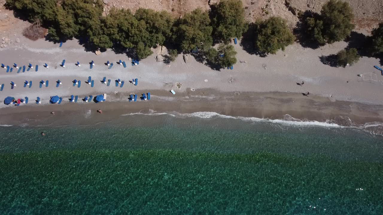 Top Down Tilting Aerial View Of Beautiful Beach in South Crete, Revealing Dramatic Cliffs Of Sfakia Area in the Mediterranean Sea