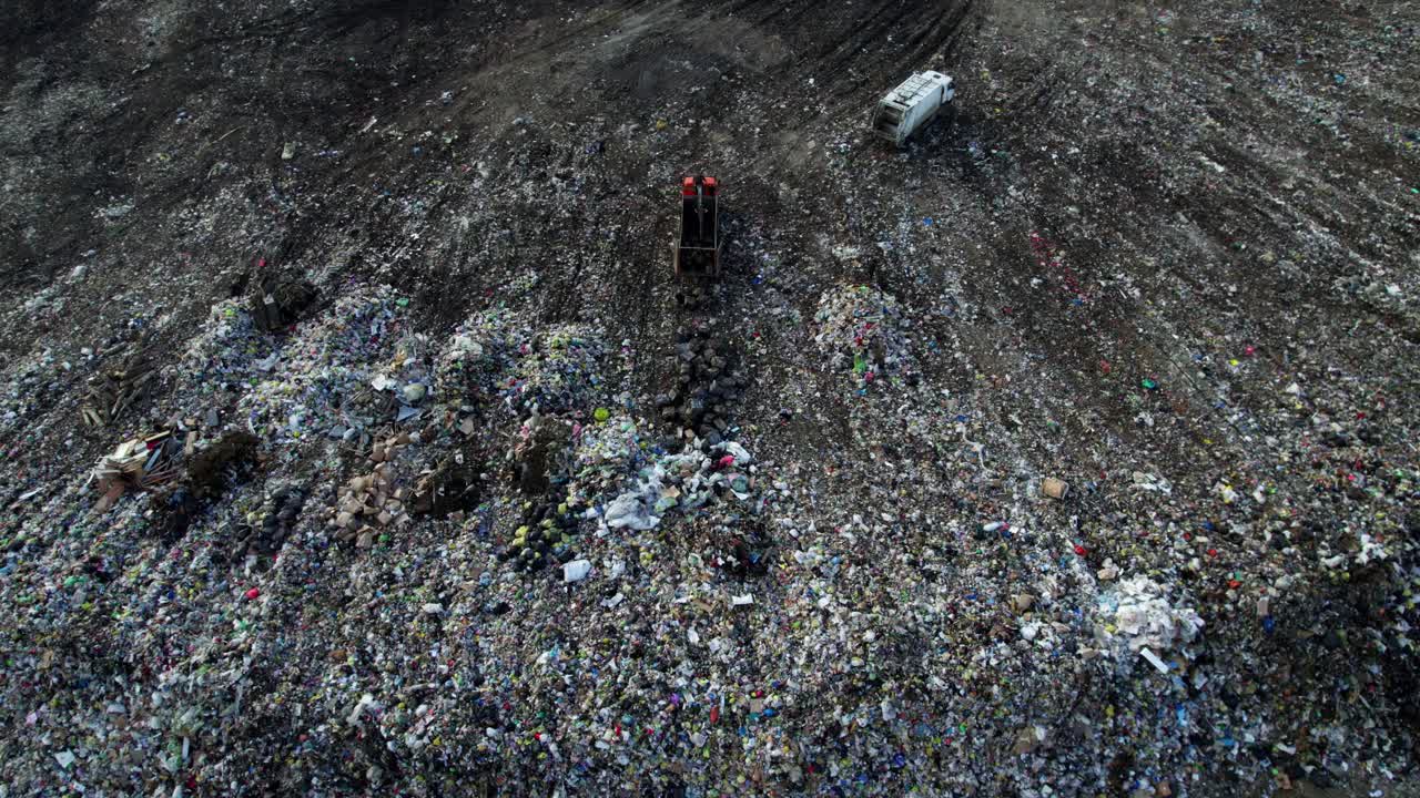 Aerial view of a landfill with garbage trucks