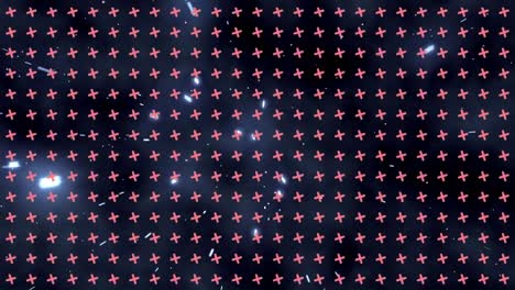 animation of pattern with rows of spinning crosses over glowing spots