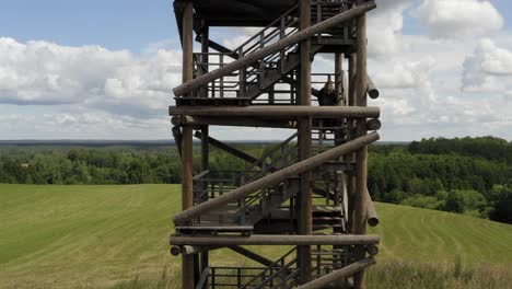 Beautiful-still-and-steady-rising-aerial-shot-of-girl-climbing-tower