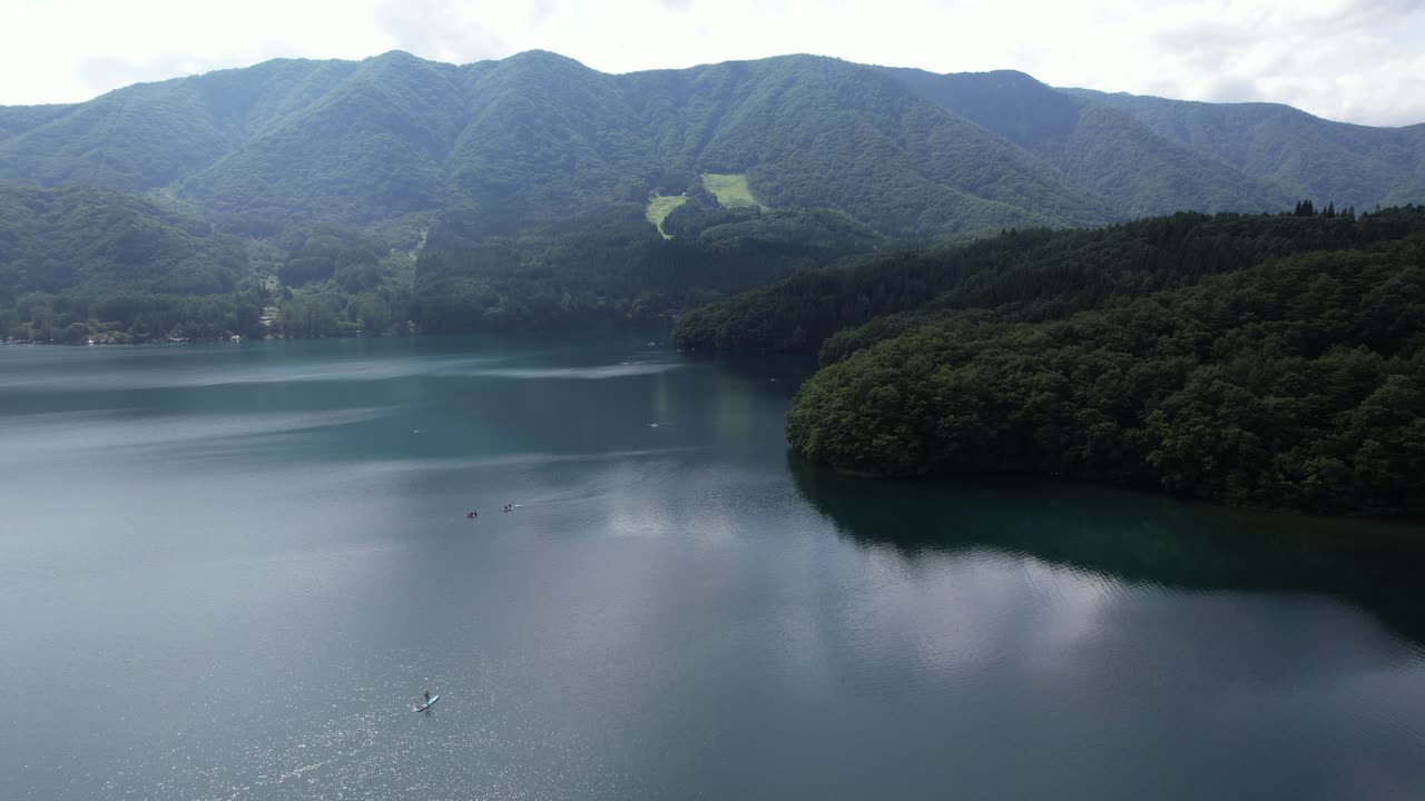 Stand-up Paddle Boarding In Summer At Lake Aoki In Omachi, Nagano Prefecture, Japan. Aerial Wide Shot