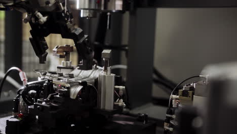 automated robot arm and welder working a metallic piece at an industrial facility