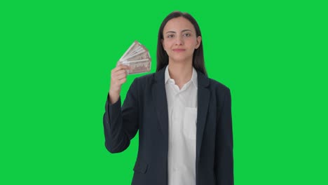 Indian-business-woman-using-money-as-fan-with-cunning-smile-Green-screen