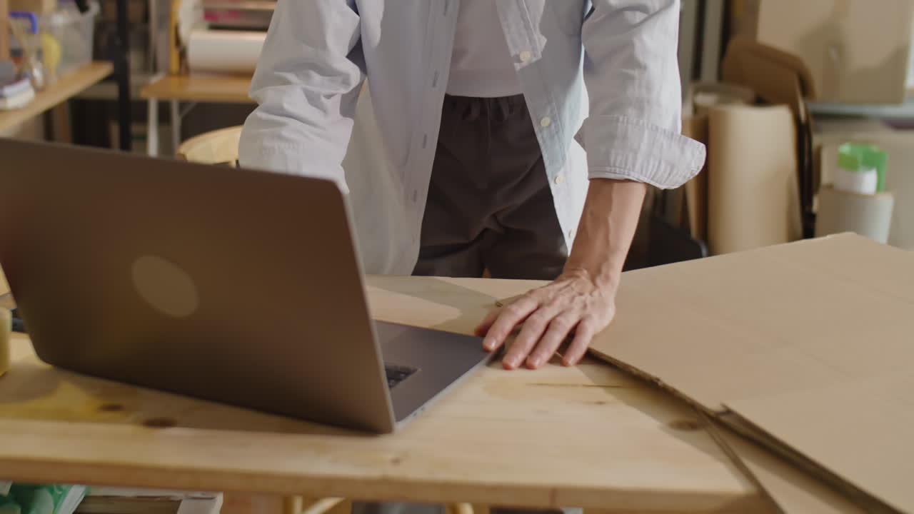 Woman Using Laptop in Delivery Service Office