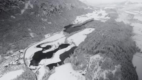 Winter,-Austria,-snow-covered-landscape-with-lakes,-forest-and-mountains,-cloudy