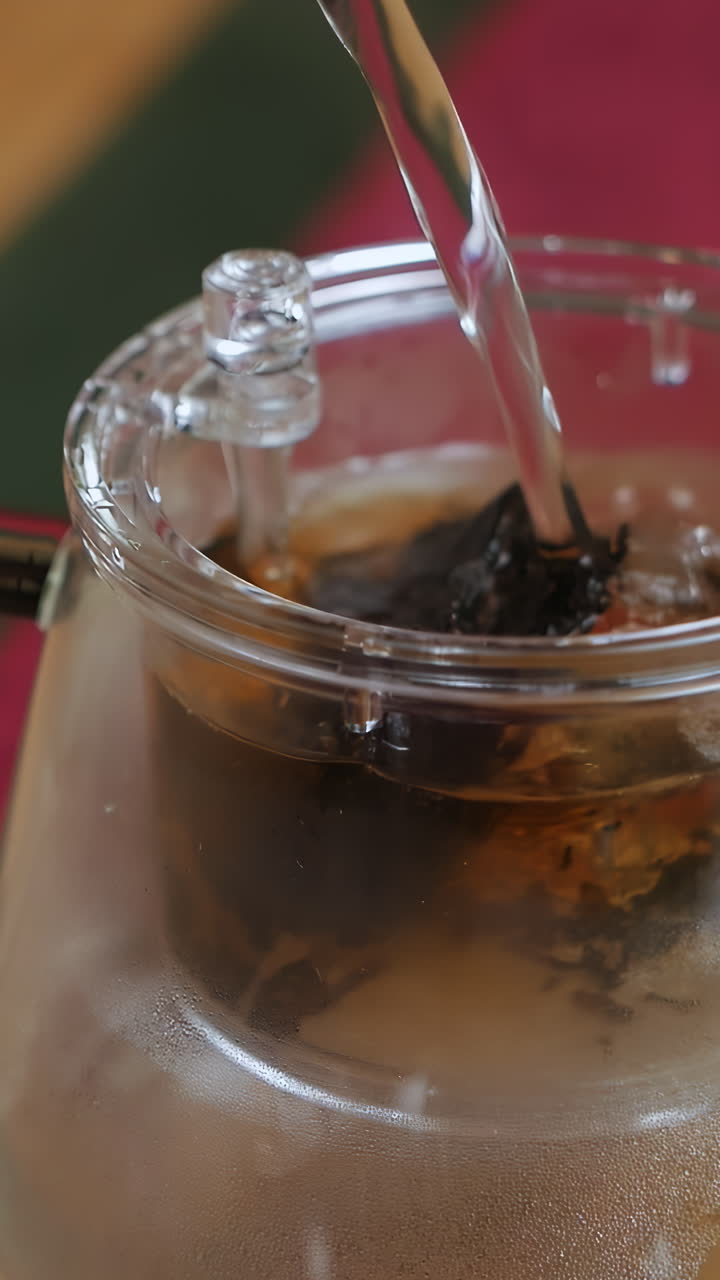 Pouring Hot Water into Glass Teapot
