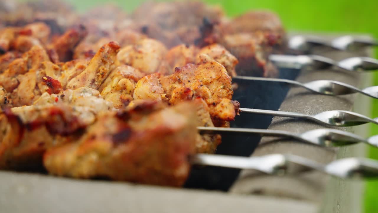 Close-up of shashlik grilling on skewers outdoors, vibrant and appetizing