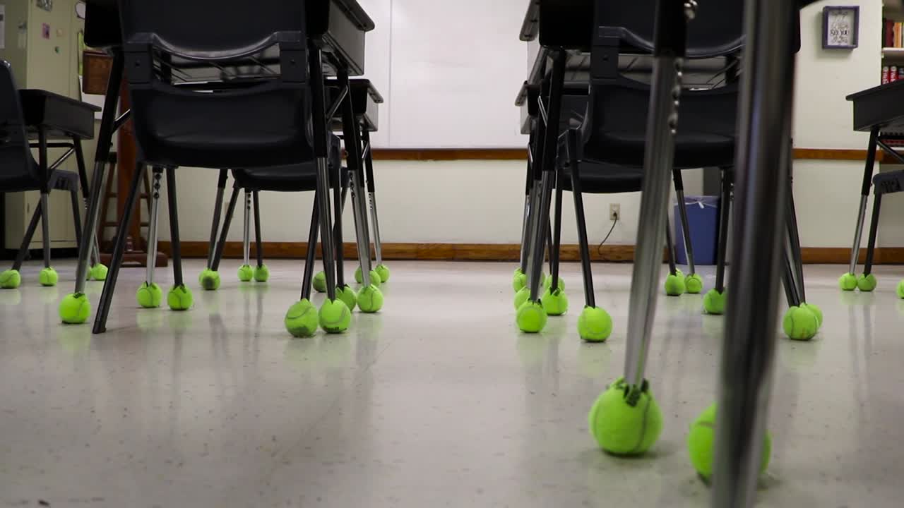 Classroom slider clip of empty desks and chairs. Education and learning scene
