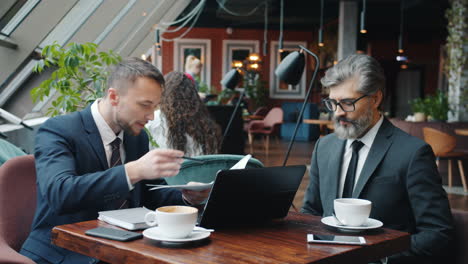 businessmen in a coffee shop meeting