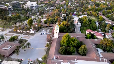 drone shot of an orbit of the entire los dominicos church complex in santiago de chile - aerial view