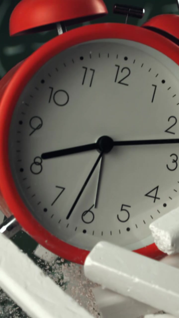 Red Alarm Clock and Chalk Floating Upwards in Slow Motion