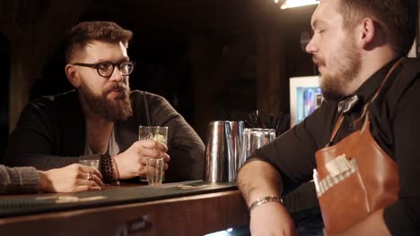 men talking at a bar counter