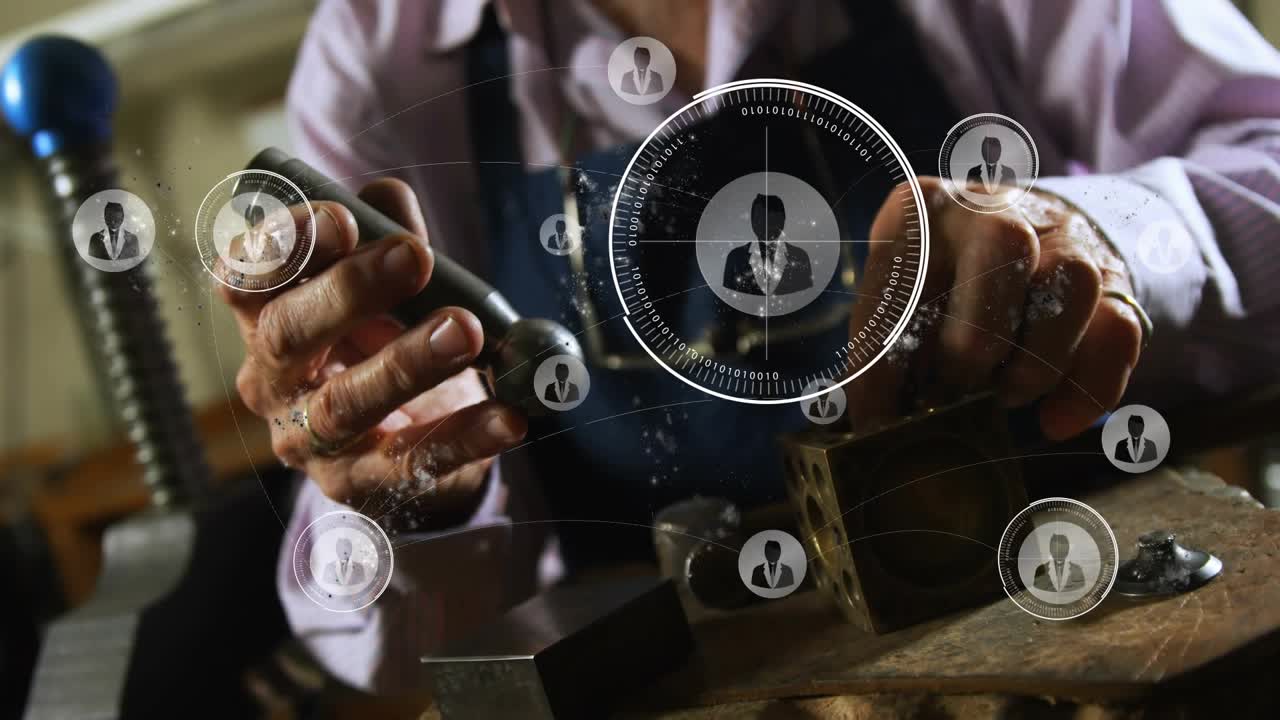 Senior metalsmith placing stamp on metal cube, hammering while HUD overlaying hand nodes