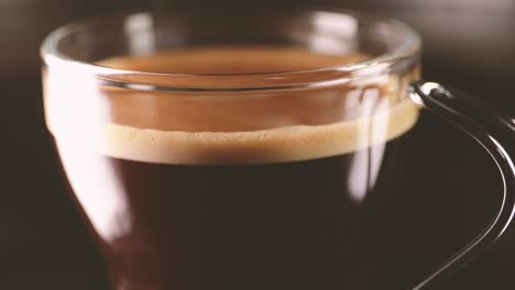 close up on hand taking glass coffee cup. static shot