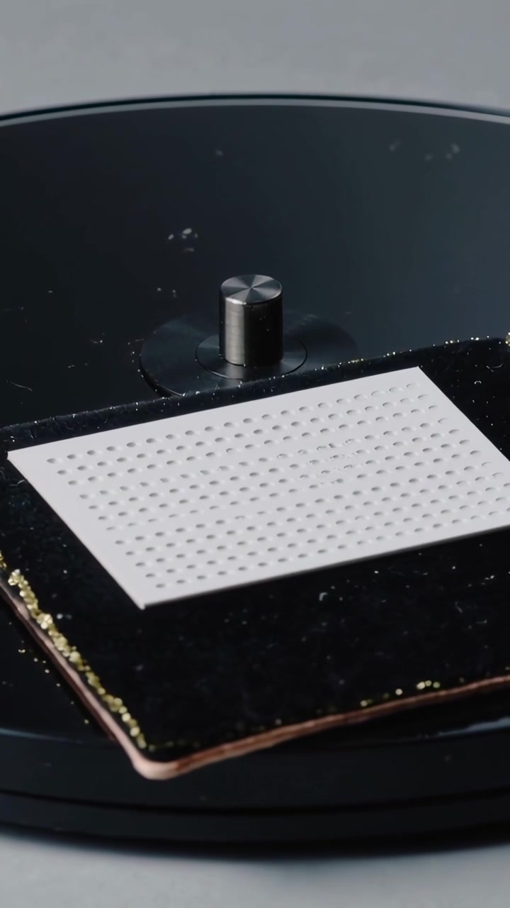 Vertical video: Panning camera showing white sheet on black velvet with metal peg on base for show