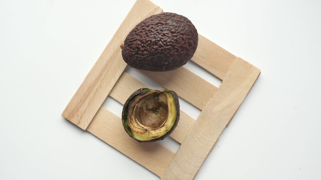 aguacates podridos en una bandeja de madera