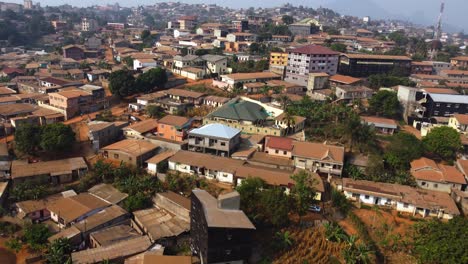 Drone-shot-over-suburban-streets-and-homes-of-Yaounde,-sunny-Cameroon