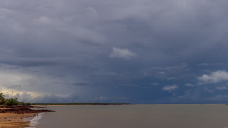 Timelapse-of-tropical-storm-clouds-moving-over-Dundee-Beach,-showing-beach