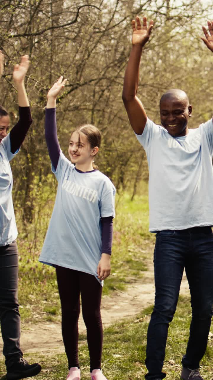 Diverse Group of Volunteers Huddle Hands and Celebrate Teamwork in Nature