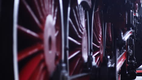 close-up of red wheels of a vintage steam train
