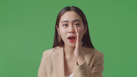 close up of asian business woman doing ooh face on green screen background in the studio