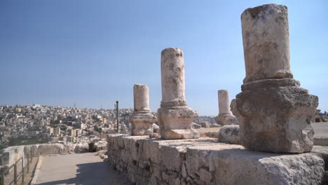 ancient ruins of amman citadel, jordan with cityscape in skyline, pillars, walls of roman and byzantine city, full frame