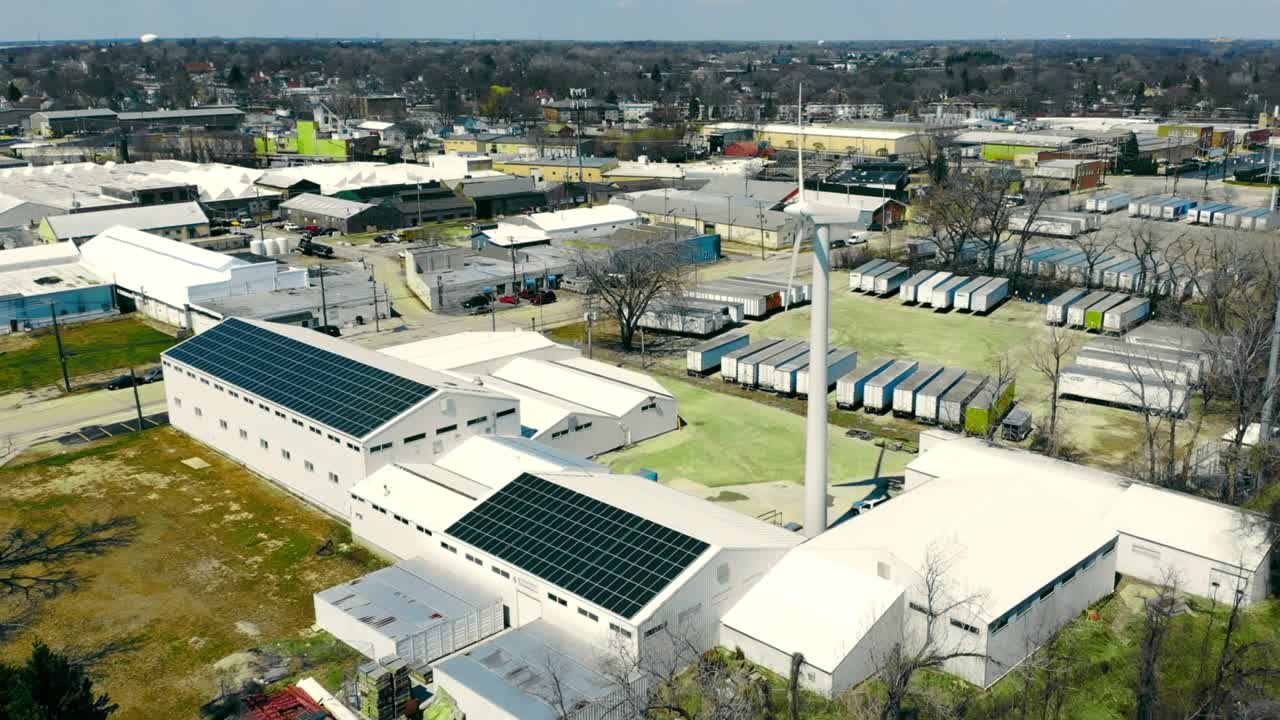 A small power plant for the enterprise consisting of a windmill and solar panels. Alternative energy for enterprises. Mini power plant in the city.