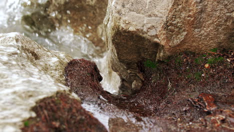 waves in slow motion hitting the rocky shore and crashing with power