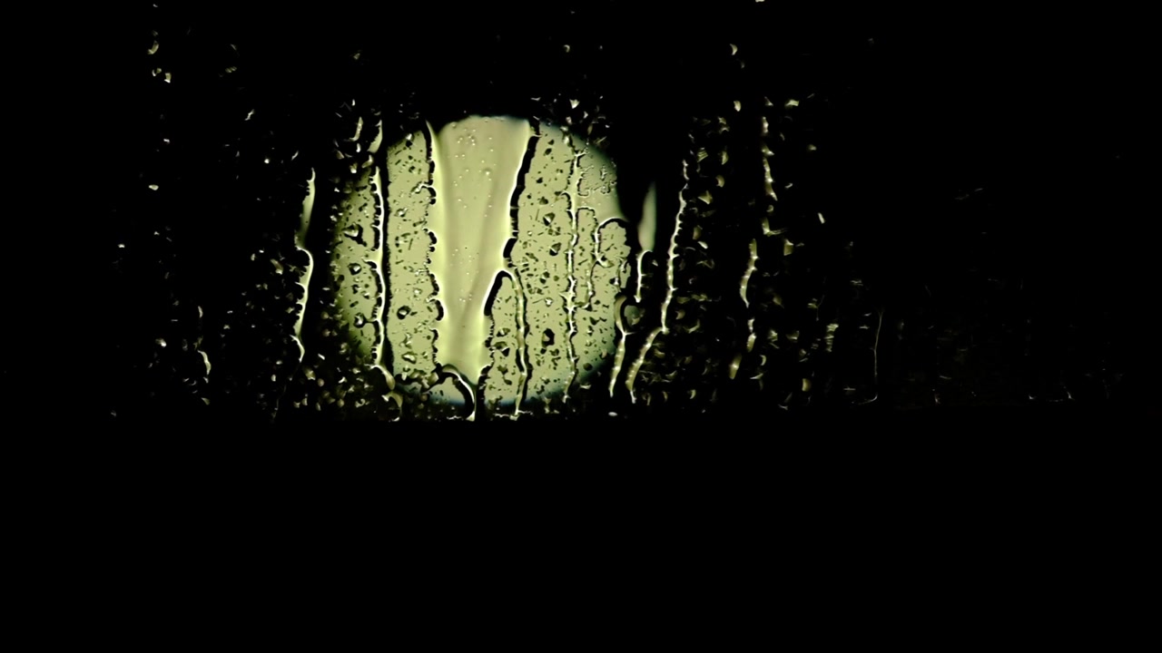 Bokeh light through a wet window in the rain