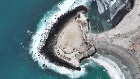 aerial view of a coastline with buildings and waves