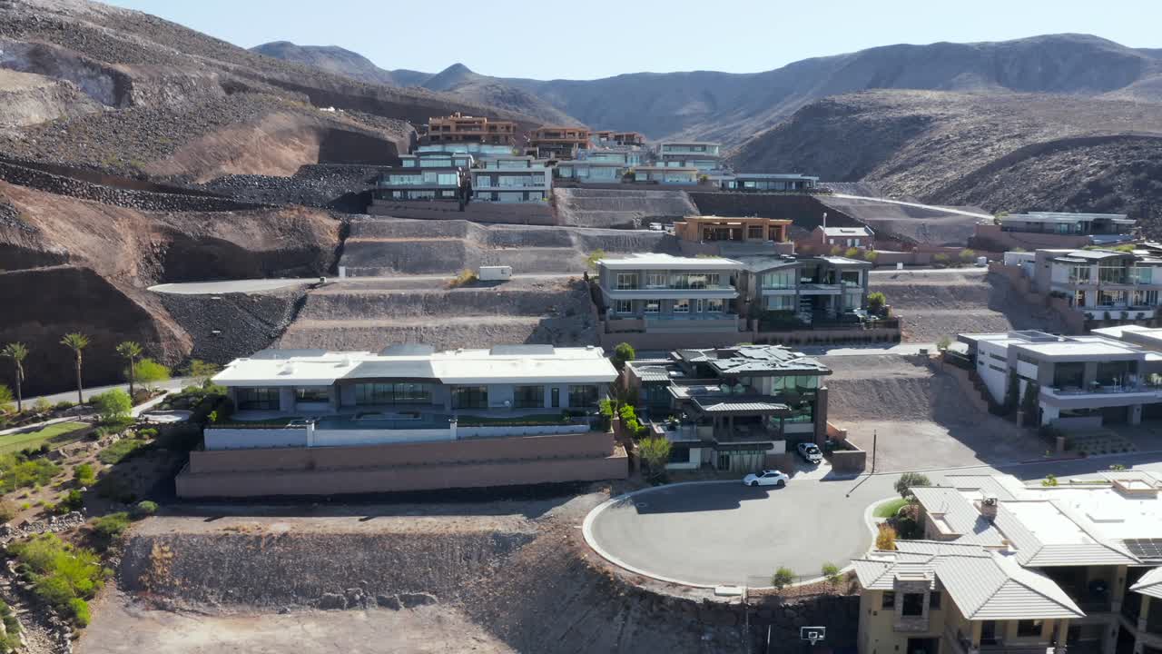 Aerial pan of real estate construction development houses on mountain edge